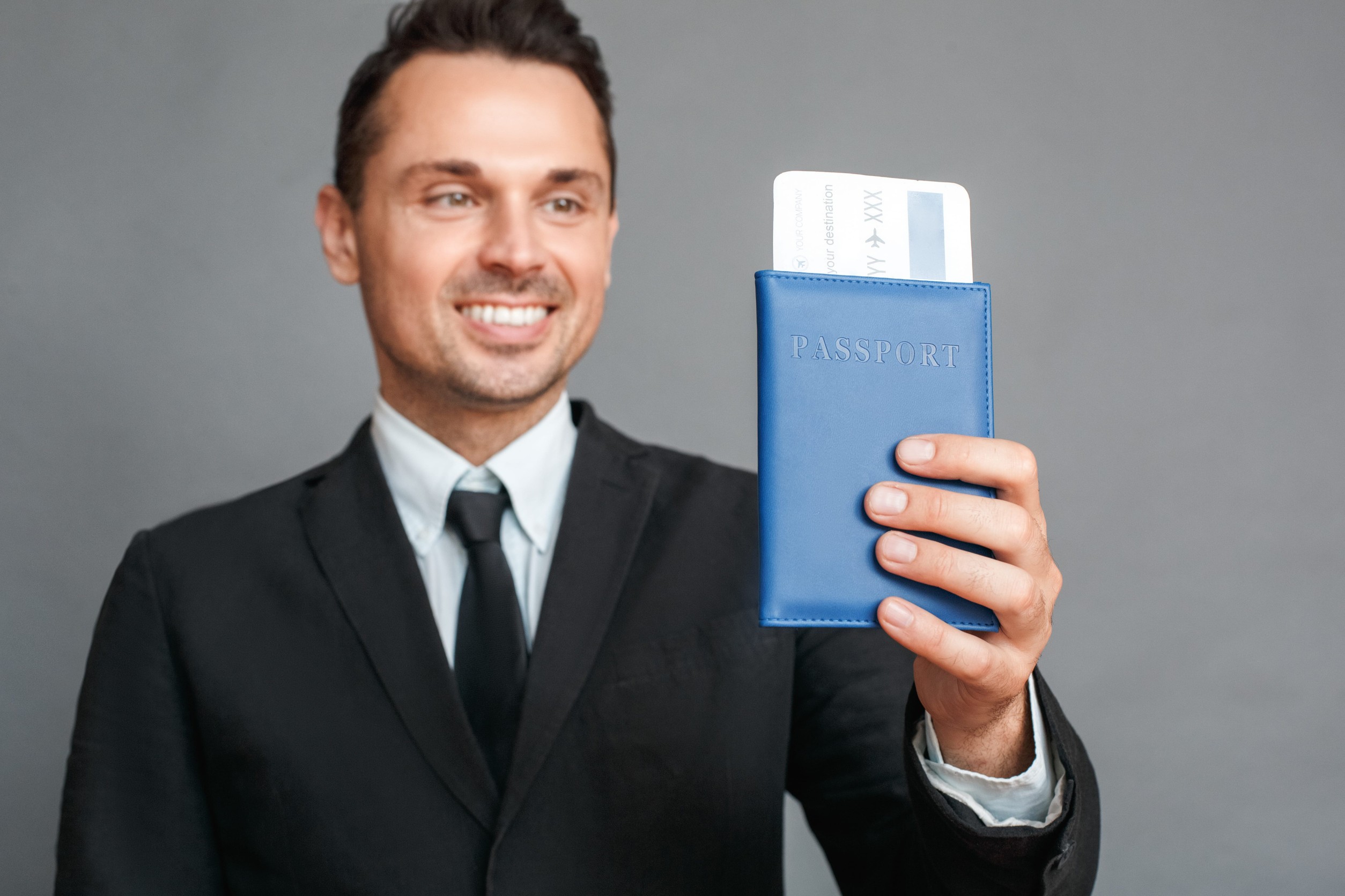 Businessman Studio Standing Isolated On Grey With Passport