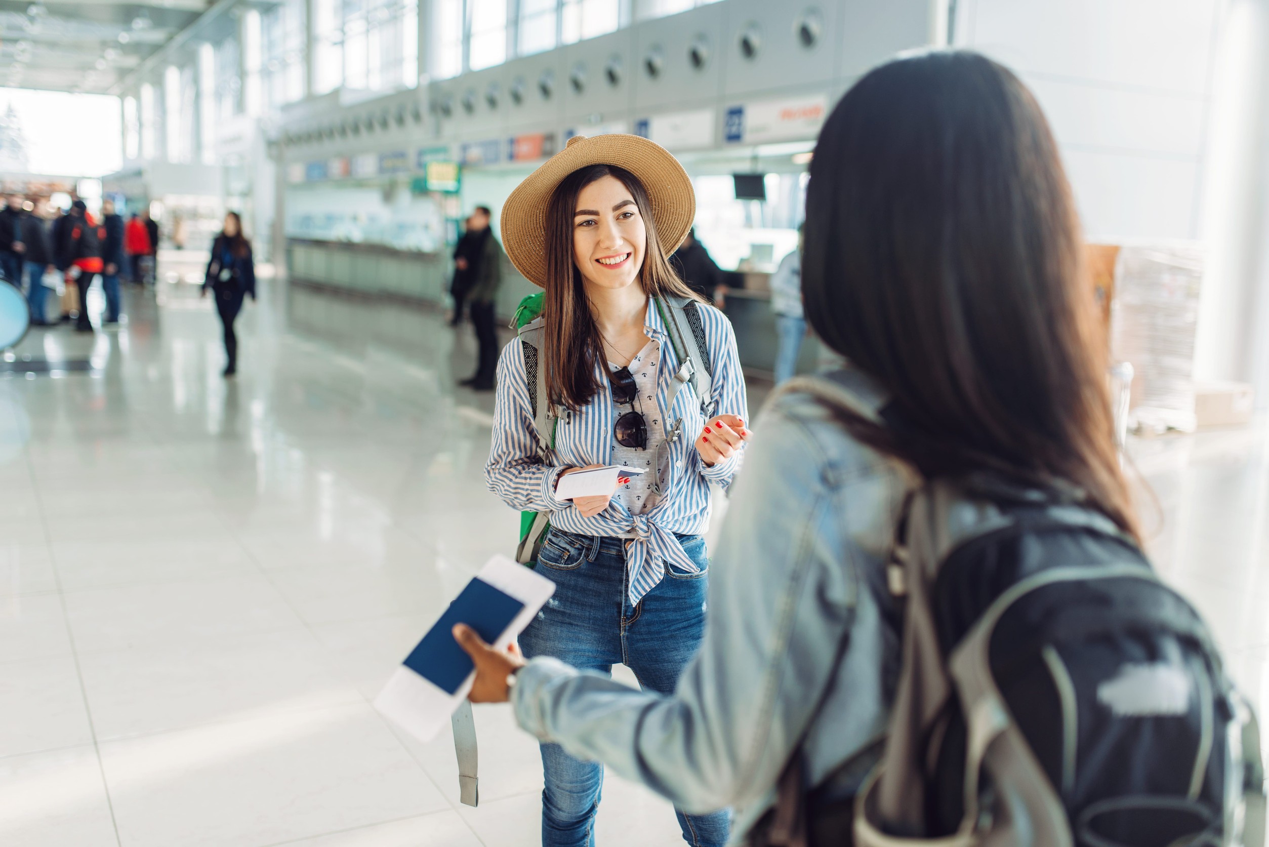 Female Tourists With Bags And Passport In International Airport