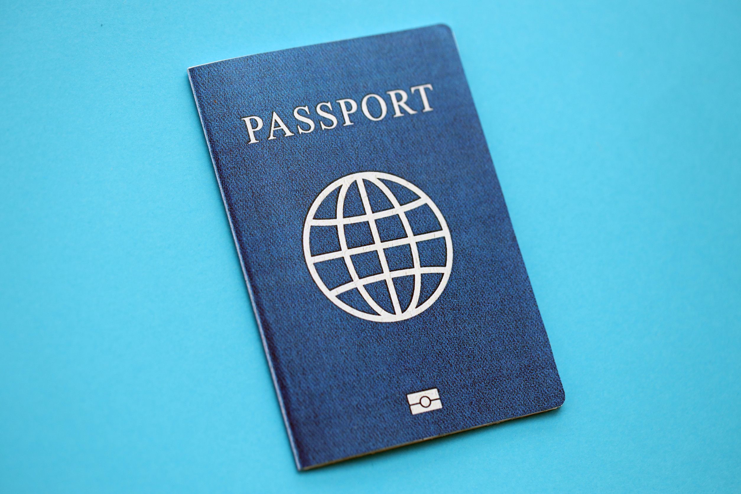 Generic Passport Book On Light Blue Paper Background