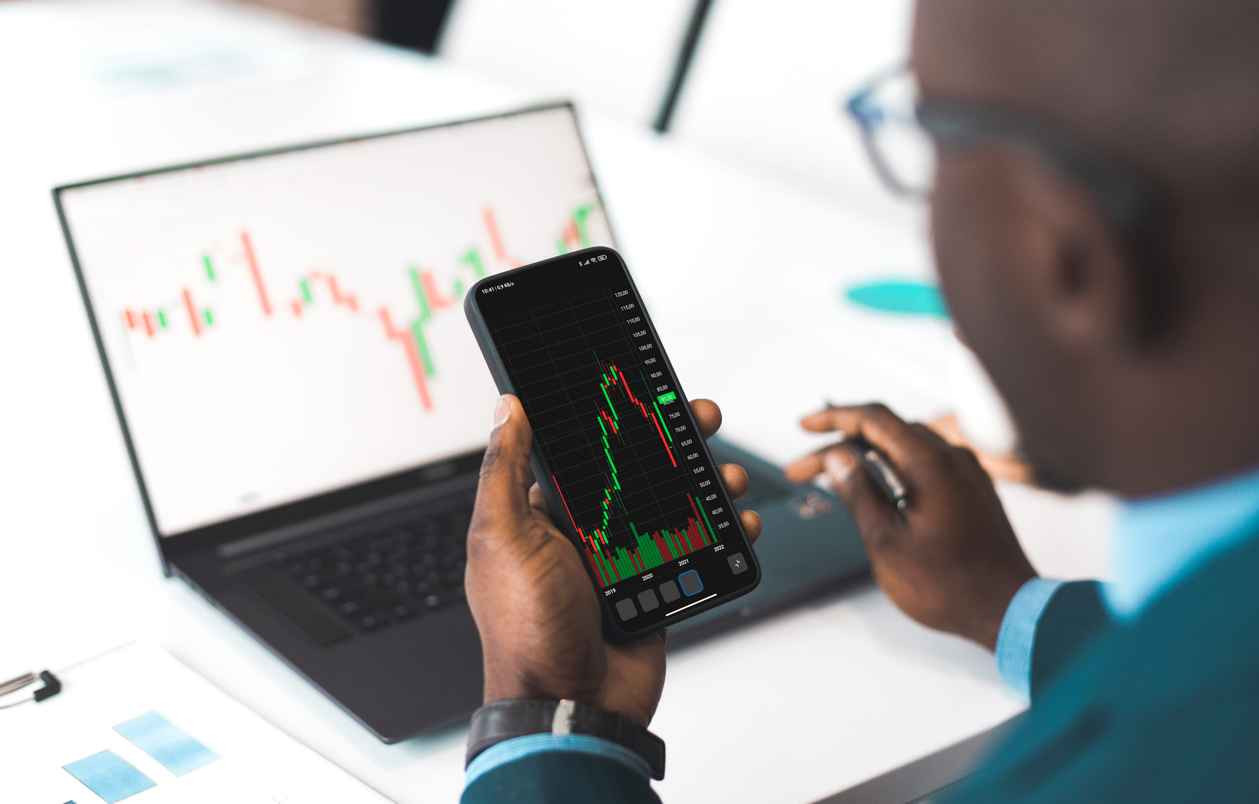 Investor analysing market data on a smartphone