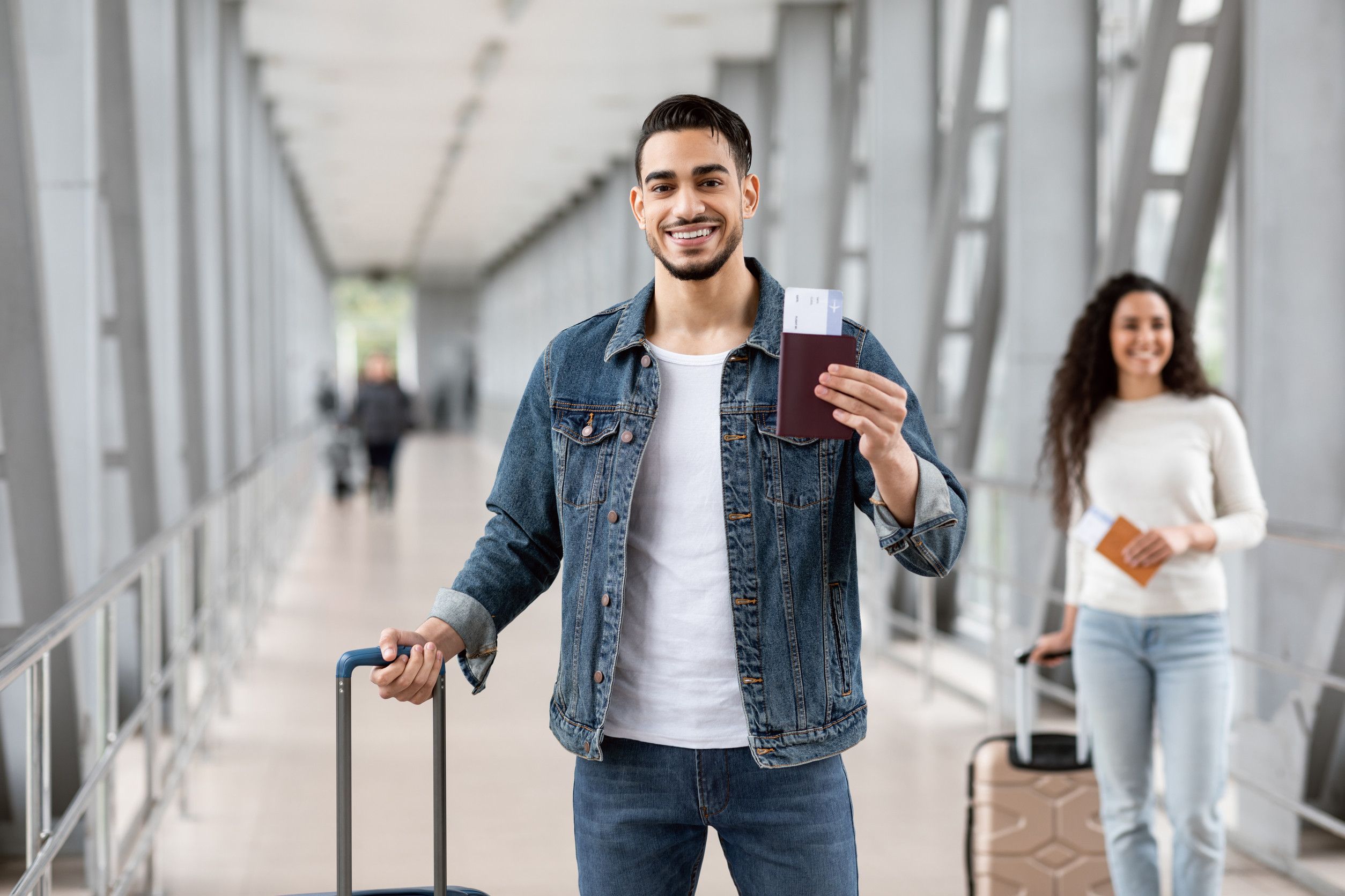 Man Posing With Passport And Tickets