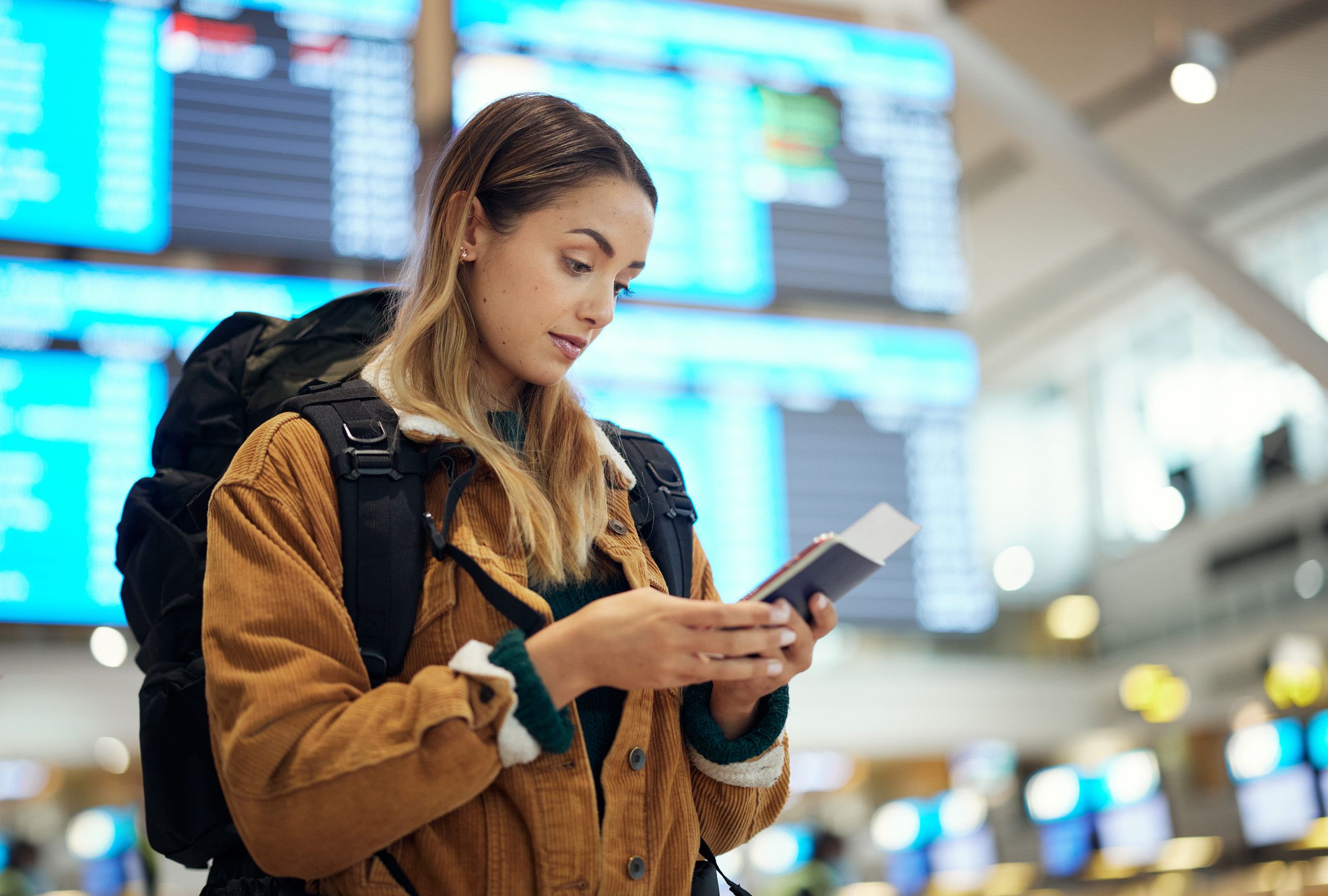 Passport And Woman With Phone At Airport Lobby