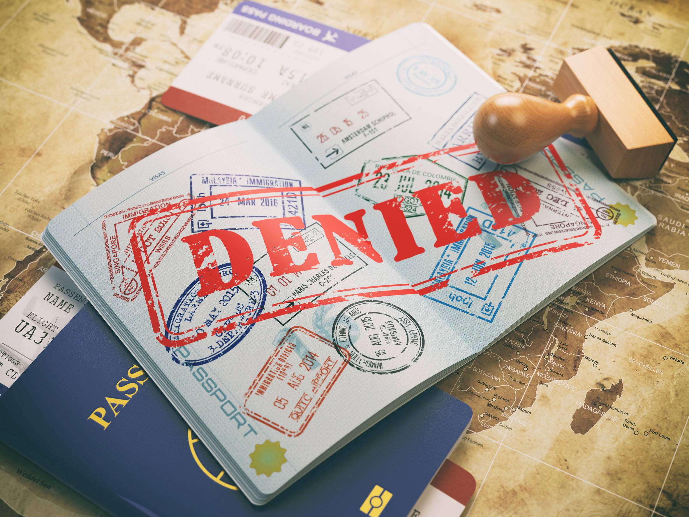 Passport With Denied Visa Stamp On The Map Of The World And Airline Boarding Pass Tickets Travel