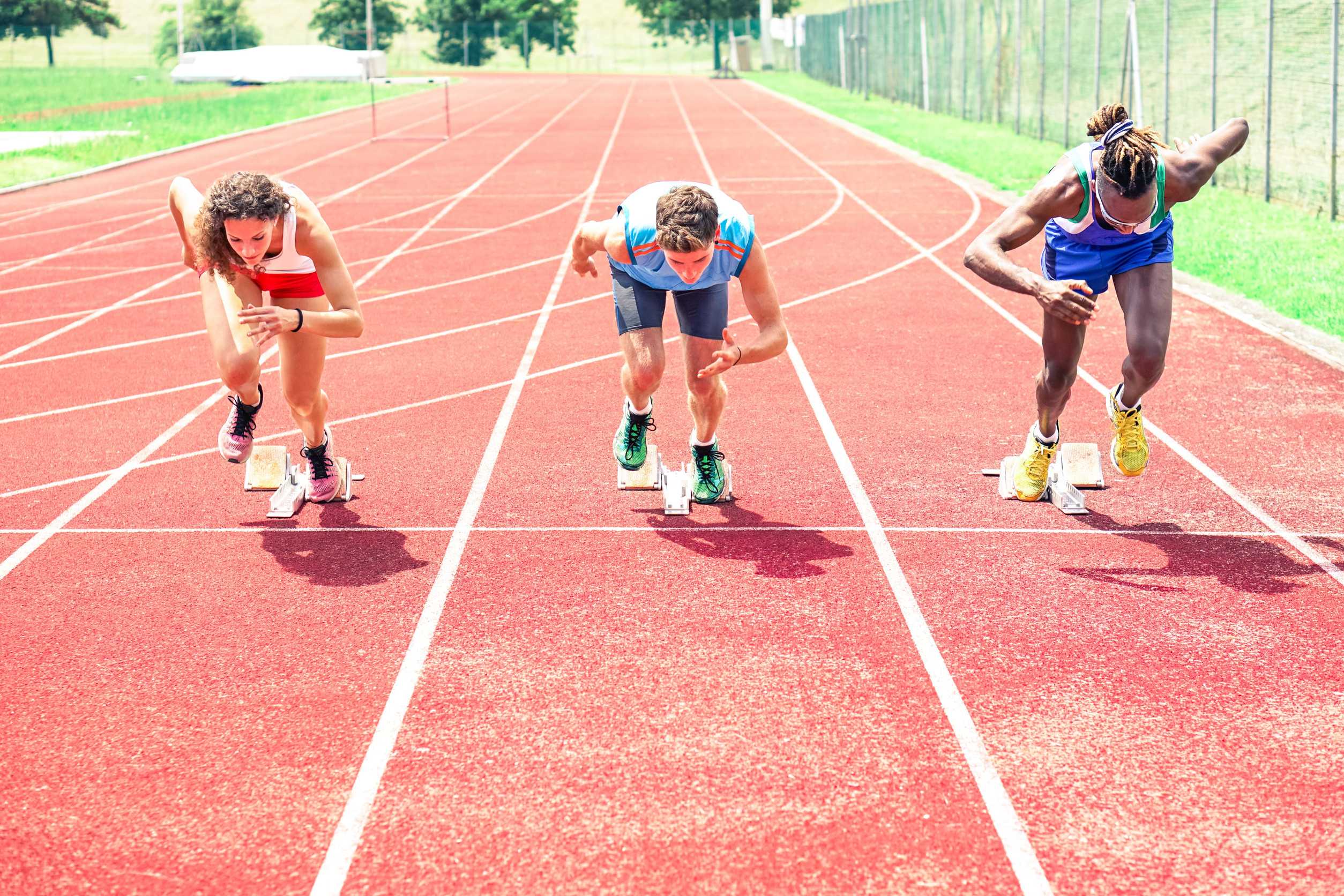 Runners On The Red Track Preparing For A Sports Event