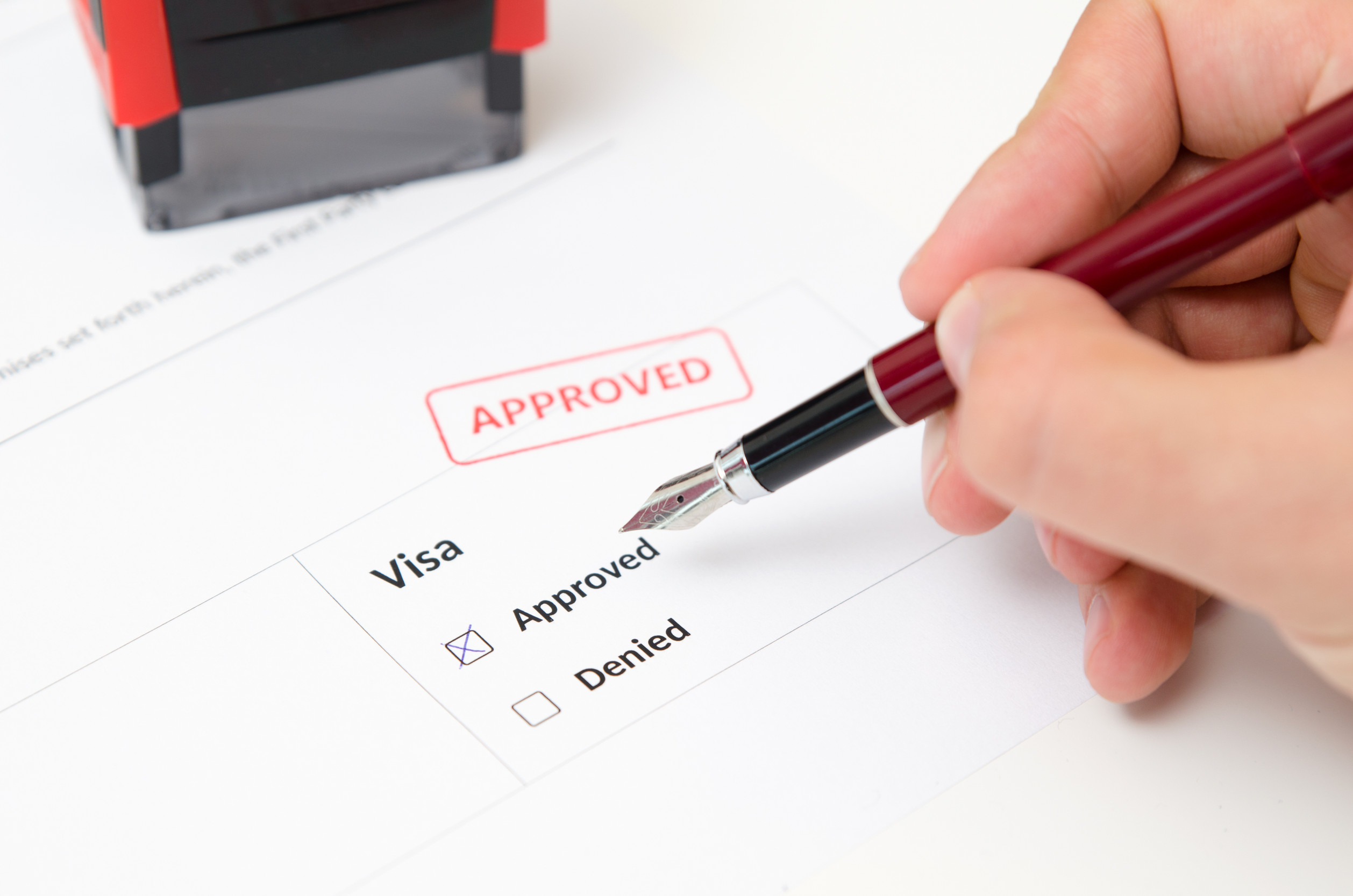 Visa And Approved Stamp On A Document Form Immigration And Travel Concept
