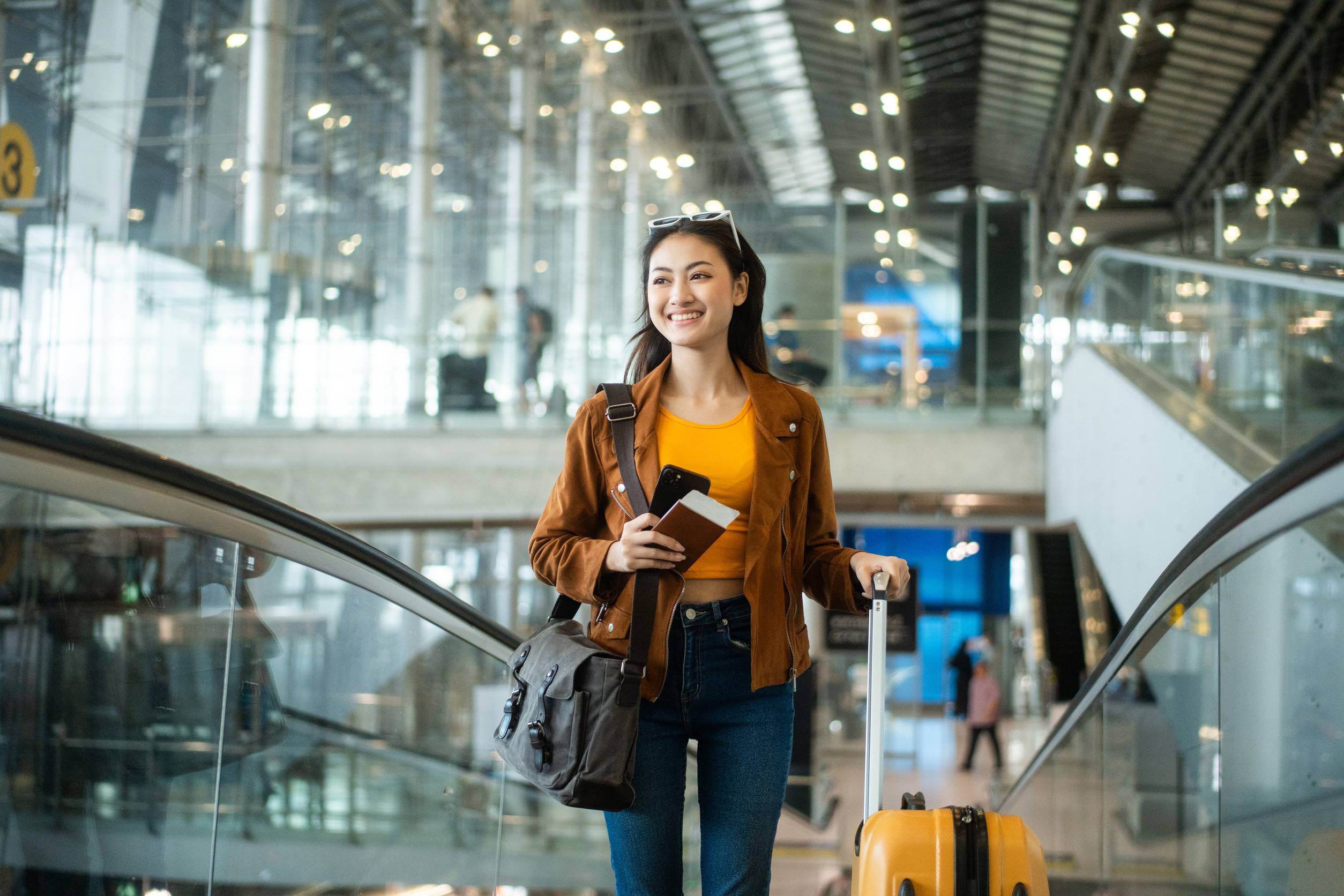 Woman Holding Ticket Passport And Smartphone At The Airport