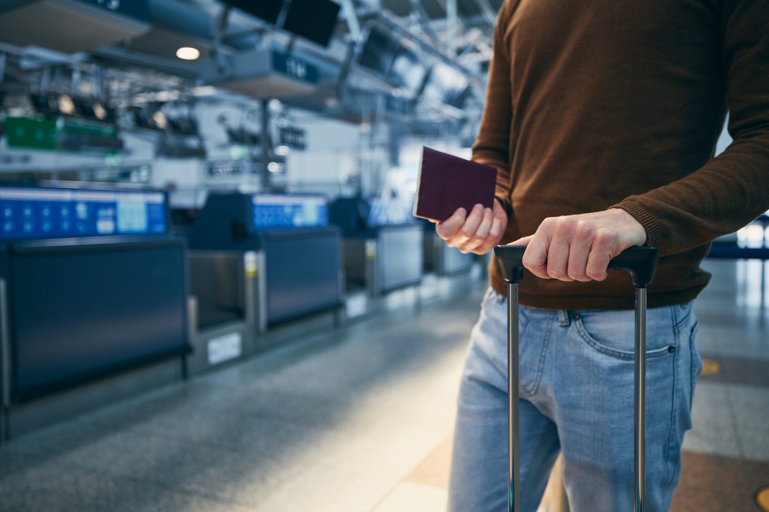 Young Man Holding Suitcase And Passport